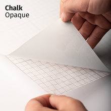 Load image into Gallery viewer, Chalk Opaque adhesive textile film with grid-lined non-woven backing, shown being peeled back to demonstrate its opaque appearance and easy application.